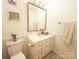 Bathroom with a white toilet, white vanity and a gold framed mirror above the vanity at 1323 Queens Rd # 327, Charlotte, NC 28207