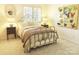 Cozy bedroom with a stylish metal bed frame, neutral carpet, and colorful butterfly artwork at 1323 Queens Rd # 327, Charlotte, NC 28207