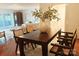 Well-lit dining room with a modern table and view into the living room and kitchen at 1323 Queens Rd # 327, Charlotte, NC 28207