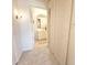Bright hallway leading to a bathroom featuring a modern vanity and lighting at 1323 Queens Rd # 327, Charlotte, NC 28207