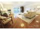 Inviting living room with hardwood flooring, stylish furniture, and a sliding door to the outside at 1323 Queens Rd # 327, Charlotte, NC 28207