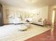 Open living room with an area rug, neutral sofa, stylish decor, and hardwood flooring at 1323 Queens Rd # 327, Charlotte, NC 28207