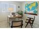 Bright office space with wooden desk, large map, and plenty of natural light at 1323 Queens Rd # 327, Charlotte, NC 28207