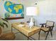 Comfortable office space featuring vintage world map, wooden desk, and natural light at 1323 Queens Rd # 327, Charlotte, NC 28207