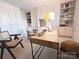 Stylish office with built-in shelving, wooden desk, and natural light at 1323 Queens Rd # 327, Charlotte, NC 28207