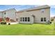 This backyard features a patio with a stone-encircled fire pit and mature landscaping at 1427 Rosemont Dr, Indian Land, SC 29707