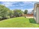 This backyard features a patio with a stone-encircled fire pit and mature landscaping at 1427 Rosemont Dr, Indian Land, SC 29707
