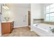 Bathroom showcasing a jacuzzi tub, walk-in shower, and stylish vanity with modern fixtures at 1427 Rosemont Dr, Indian Land, SC 29707