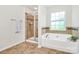Bathroom featuring a luxurious soaking tub, separate shower, and elegant tile work at 1427 Rosemont Dr, Indian Land, SC 29707