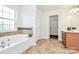 Bathroom featuring a soaking tub, a walk-in closet, and vanity with ample counter space at 1427 Rosemont Dr, Indian Land, SC 29707