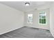 This bedroom features neutral walls, carpet flooring, and two bright windows at 1427 Rosemont Dr, Indian Land, SC 29707