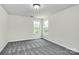 This bedroom features neutral walls, carpet flooring, and two bright windows at 1427 Rosemont Dr, Indian Land, SC 29707