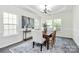 Bright dining room with stylish chandelier, large windows, and elegant decor creates an inviting atmosphere at 1427 Rosemont Dr, Indian Land, SC 29707