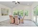 Bright dining area with neutral tones, large windows, and a sliding glass door providing access to the outdoors at 1427 Rosemont Dr, Indian Land, SC 29707