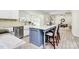 Kitchen showcasing a marble island with seating, stainless steel appliances, and ample natural light at 1427 Rosemont Dr, Indian Land, SC 29707