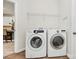 Functional laundry room equipped with modern Samsung washer and LG dryer, ample lighting, and storage at 1427 Rosemont Dr, Indian Land, SC 29707