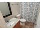 Bathroom featuring a granite vanity, toilet, shower with a patterned curtain, and a framed mirror at 165 Brantley Place Dr, Mooresville, NC 28117