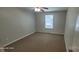 This bedroom features neutral walls, carpeted floors, a ceiling fan, and natural light from a window at 165 Brantley Place Dr, Mooresville, NC 28117