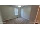This bedroom features neutral walls, carpeted floors, a ceiling fan, and a single window at 165 Brantley Place Dr, Mooresville, NC 28117