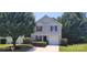 Charming two-story home featuring a single-car garage and manicured landscaping at 165 Brantley Place Dr, Mooresville, NC 28117