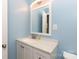 A full bathroom with light blue walls, vanity with a mirror, a bright light and white cabinets at 1655 Woodhaven Rd, Rock Hill, SC 29732