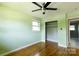 A bedroom with green walls, hardwood floors, a ceiling fan and a closet at 1655 Woodhaven Rd, Rock Hill, SC 29732