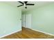 A bedroom with light green walls, a ceiling fan, and hardwood floors at 1655 Woodhaven Rd, Rock Hill, SC 29732