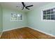 A bedroom with green walls, hardwood floors, two windows and a ceiling fan at 1655 Woodhaven Rd, Rock Hill, SC 29732