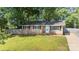 Charming brick home with a well-maintained front yard and mature trees at 1655 Woodhaven Rd, Rock Hill, SC 29732
