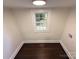 Finished attic space with hardwood floors, neutral walls, and a window view at 179 Duval Nw St, Concord, NC 28025