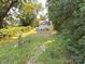 Backyard view of a home featuring a small deck and lots of grassy area at 179 Duval Nw St, Concord, NC 28025