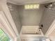 Modern bathtub with tiled walls and showerhead with natural light coming through a window at 179 Duval Nw St, Concord, NC 28025