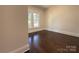 Cozy bedroom featuring hardwood floors, neutral paint, and ample natural light at 179 Duval Nw St, Concord, NC 28025