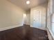 Bright bedroom with hardwood floors, white trim, and natural light from a large window at 179 Duval Nw St, Concord, NC 28025
