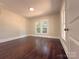 Bright bedroom featuring hardwood floors, natural light, and fresh paint for a serene atmosphere at 179 Duval Nw St, Concord, NC 28025