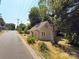 Charming home with a tan exterior, surrounded by mature trees and greenery at 179 Duval Nw St, Concord, NC 28025