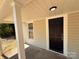 Close-up of the black front door and porch of a charming home at 179 Duval Nw St, Concord, NC 28025