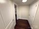 Hallway features wood floors, white trim, and leads into a kitchen and another room at 179 Duval Nw St, Concord, NC 28025