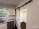 Updated kitchen with stainless steel appliances, granite countertops, and a white barn door at 179 Duval Nw St, Concord, NC 28025
