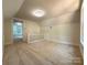 A loft area featuring neutral carpeting and a staircase at 179 Duval Nw St, Concord, NC 28025