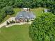 Aerial view of brick home with a large yard, in-ground pool, driveway, landscaping, and an outbuilding at 1842 Caroline Way, Fort Mill, SC 29715