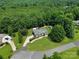 Aerial view of brick home with a large yard, in-ground pool, driveway, landscaping, and an outbuilding at 1842 Caroline Way, Fort Mill, SC 29715