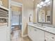 Bright bathroom featuring a granite-topped vanity, framed mirror, and a glass-enclosed shower, offering a clean and modern space at 1842 Caroline Way, Fort Mill, SC 29715