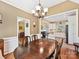 Dining room with a chandelier and an open view to the kitchen and living area at 1842 Caroline Way, Fort Mill, SC 29715