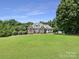 Stately brick home with a well-manicured lawn and mature trees, offering a picturesque and inviting curb appeal at 1842 Caroline Way, Fort Mill, SC 29715