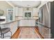 Well-lit kitchen featuring white cabinets, stainless steel appliances, and a decorative rug at 1842 Caroline Way, Fort Mill, SC 29715