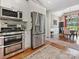 Modern kitchen with stainless steel appliances, granite countertops, and an open view to the dining room at 1842 Caroline Way, Fort Mill, SC 29715