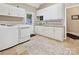 Well-equipped laundry room with white cabinetry, modern machines, and tiled floors, providing a clean and functional space at 1842 Caroline Way, Fort Mill, SC 29715