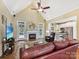 Open-concept living room with fireplace, hardwood floors, and an open view of the kitchen at 1842 Caroline Way, Fort Mill, SC 29715
