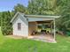 Versatile outbuilding with a covered carport area for vehicle or equipment storage, set within a green lawn at 1842 Caroline Way, Fort Mill, SC 29715